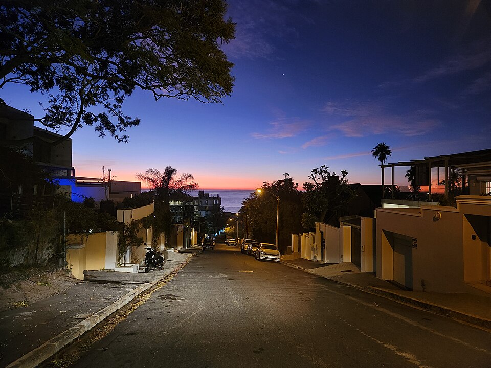 A residential street running down to the Atlantic at dusk