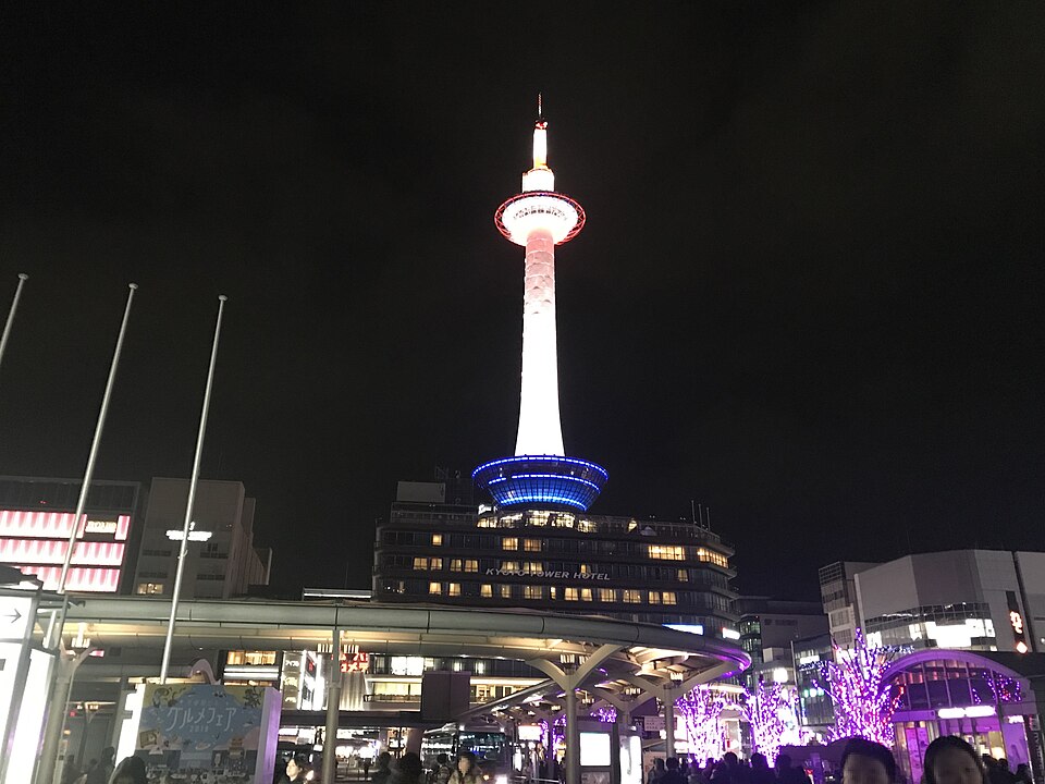 Kyoto Tower lit above the station forecourt at night