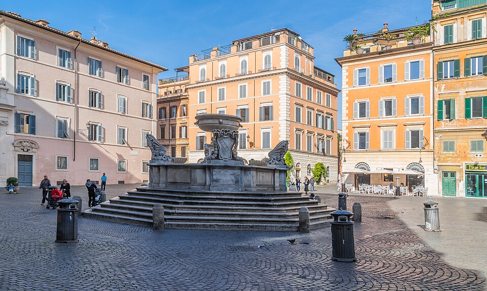 The fountain and ochre facades of Piazza Santa Maria in Trastevere