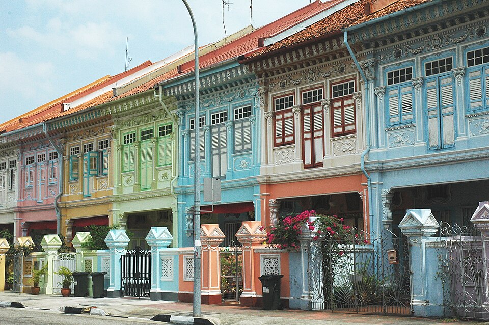 A terrace of pastel Peranakan houses with ornate plasterwork