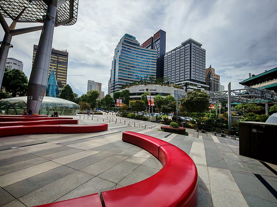 Red serpentine benches on the Orchard Road plaza below the malls