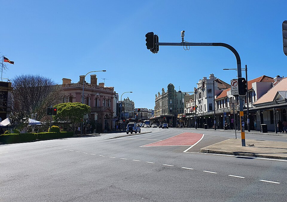 The King Street and Enmore Road corner, Victorian shopfronts under a clear sky