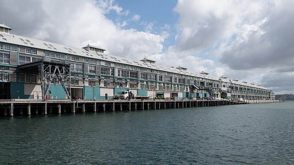 The green-and-white timber Finger Wharf running along the water