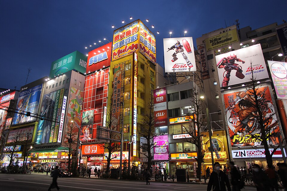 Chūō-dōri at dusk, electronics and comics signs stacked up the facades