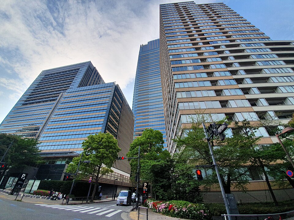 Tokyo Midtown’s towers from street level, trees along the crossing
